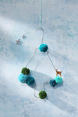 Christmas tree handmade from wire coat hanger and pompoms