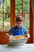 Boy preparing cauliflower and suqash roast