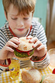 Boy eating green burgers