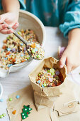 Kid mixing 'reindeer food' with seeds, oats and sweets