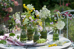 Meadow flowers in nicely dressed bottles