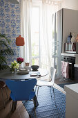 Round dining table in small, blue-and-white kitchen-dining room