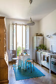 Rustic wooden cupboard, turquoise accents and stainless steel kitchen units