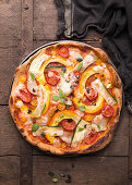 Vegan spelt pizza with pumpkin, zucchini, tomatoes and almond cheese