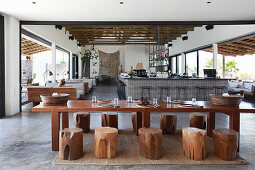 Set table with tree-stump stools in hotel lobby