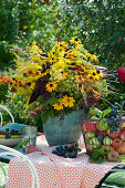 Autumn bouquet of sun hat, sun bride, sun eye, fennel, goldenrod and Chinese reed flowers