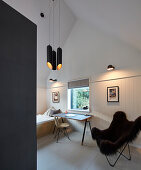 Fur Butterfly chair next to desk in bedroom in shades of grey