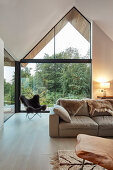 Modern living room with open roof space and glazed gable end wall