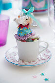 Circus elephant in cup on table set for birthday party