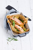 Salmon on green asparagus cooked in parchment paper