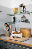 Glass shelves above kitchen worksurface