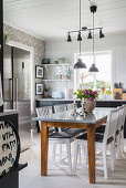 Dining table in large kitchen-dining room in Scandinavian country-house style