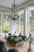 Chandelier above autumnal flower arrangement on dining table