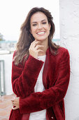 A young woman wearing a red coat