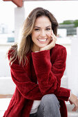 A young woman wearing a red coat