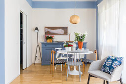 White Tulip Table and blue sideboard in dining area