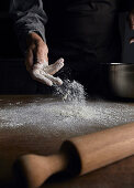 Sprinkling flour onto a table