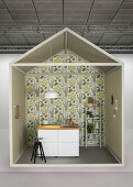 Creative idea for kitchen area with black sink unit and shelves against plant-patterned wallpaper