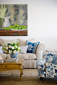 Blue-and-white armchair and ecru sofa in living room