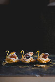 Choux pastry swans with white russian cream