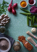 An arrangement of soba noodles, spices, oyster mushrooms, vegetables and red onions