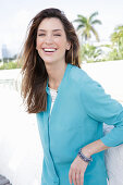 A young woman wearing a blue shirt blouse