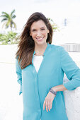 A young woman wearing a blue shirt blouse