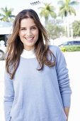 A young woman wearing a lilac jumper