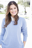 A young woman wearing a lilac jumper