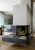 Modern fireplace in open-plan interior