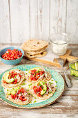 Home made tortillas with shredded cooked chicken, avocao and tomato salsa