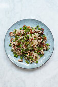 Millet salad with peas, dates and almonds