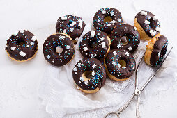 Vegan oven-baked donuts with dark icing and wintery sugar decor