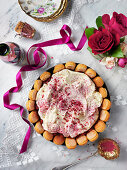 Valentines cake with frosting, raspberries, raspberiy powder and biscuits