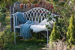 Bench with fur and blanket in the pre-Christmas garden