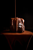 Chocolate flows on a mini chocolate cake