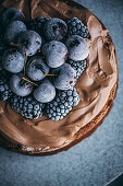 Cake with chocolate cream Frosting and Frozen Berries