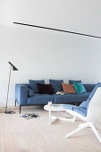 Blue, Scandinavian-style sofa in living room with wooden floor
