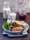 Oven baked pancake with lingonberry jam and salad