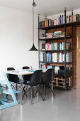 Pale blue high chair and black shell chairs around dining table