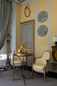 Decorative metal crown on side table in old yellow parlour