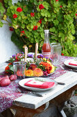 Wreath of flowers on set table on late summer terrace