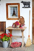 Colourful potatoes and late-summer bouquet outside farmhouse