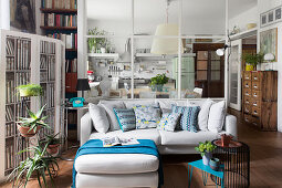 Glass partition between kitchen and living area with chaise sofa