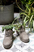 Shoes used as original planters on balcony