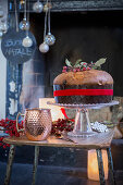 Panettone on table in front of festively decorated fireplace