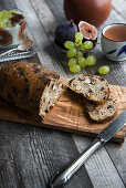 Sliced fruit bread with tea, grapes and figs