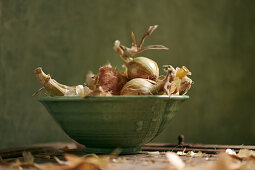 Onions in a green ceramic bowl