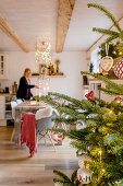 Woman at dining table in decorated for Christmas