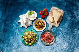 Antipasti: Various types of cheese, pickled olives, ham and pasta
